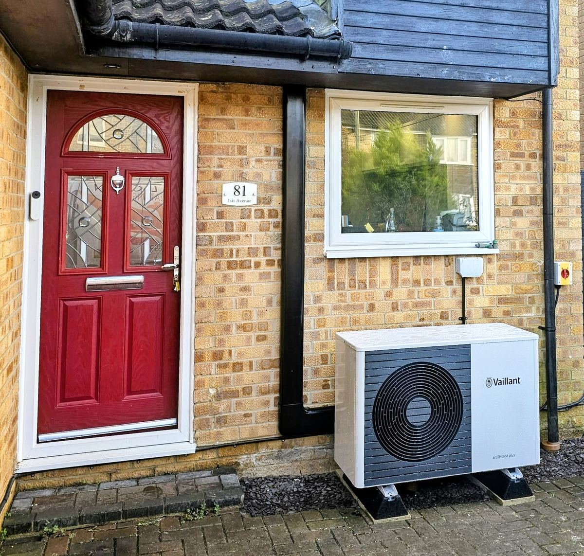 Vaillant air source heat pump installation beside a front door