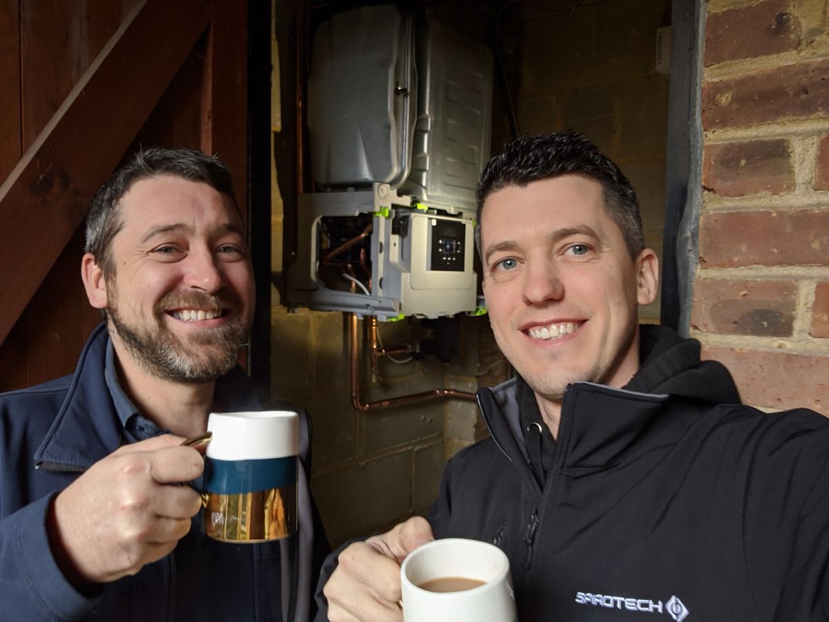 David and a colleague celebrating a completed heat pump installation